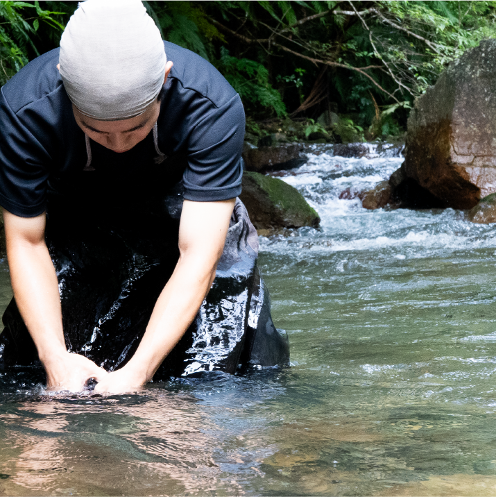 Craftsman washing leather in the river