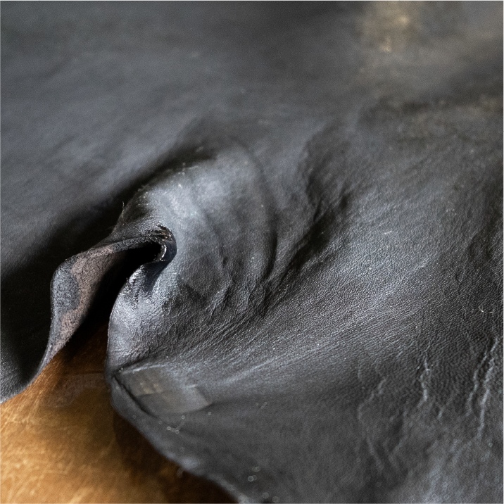 Close-up texture of dark dyed leather